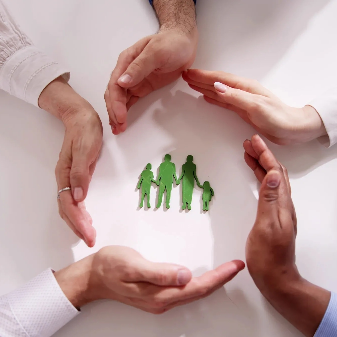 Warm multigenerational family scene with older adult, family members, and caregiver interacting naturally at home